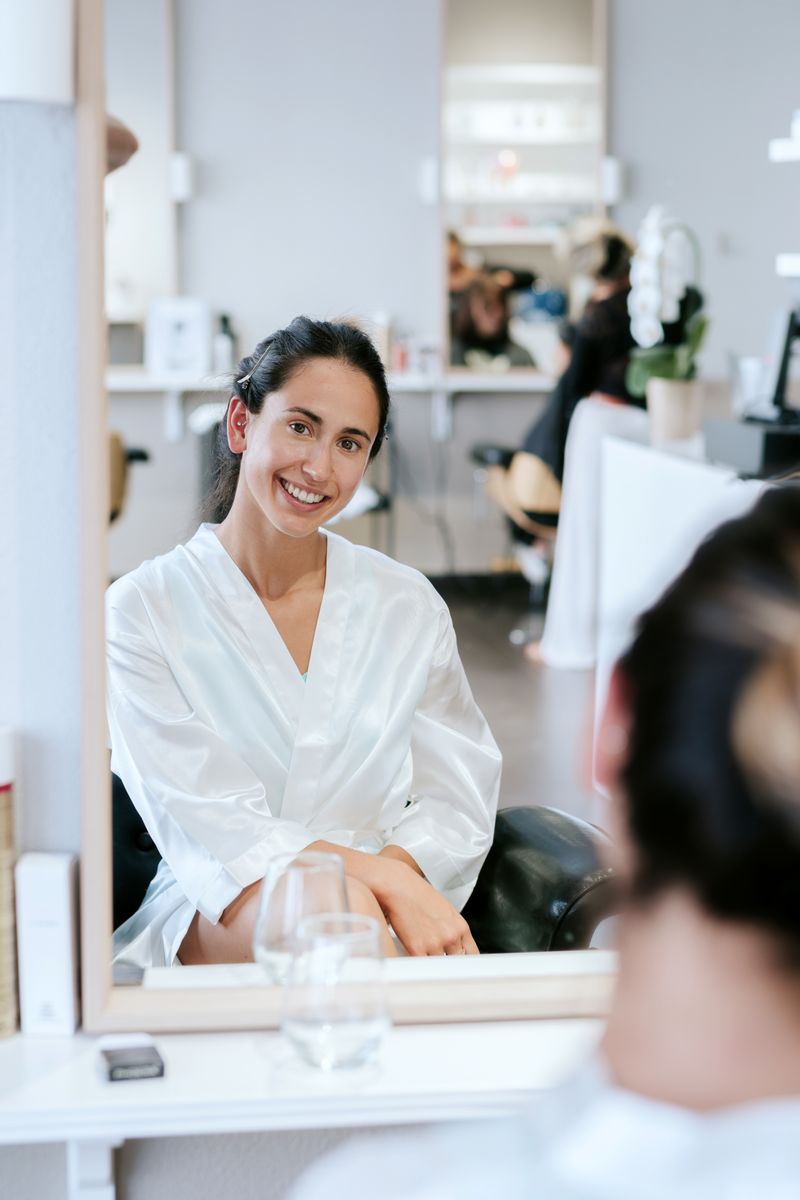 A guest smiling in a spa robe before her treatment
